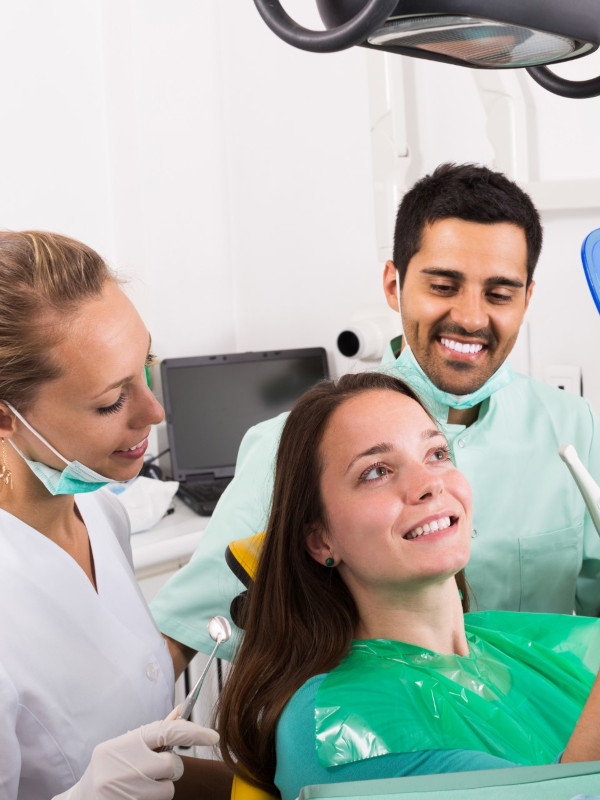 dental staff helping patient with dental care