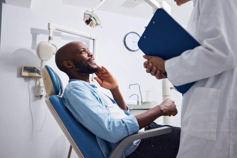 man sitting in dentist's chair for dental care in Valparaiso, Indiana; Valpo dental care